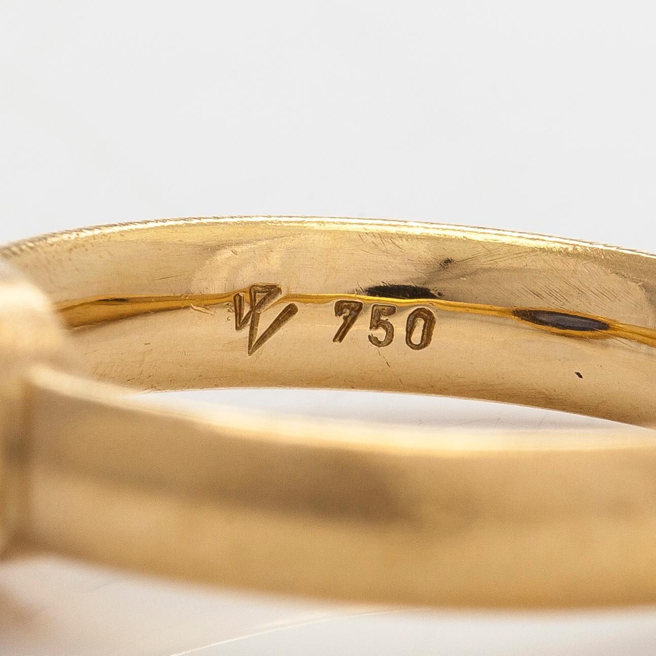 An 18K gold ring with a cabochon-cut sapphire.