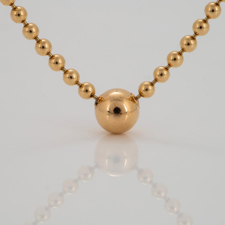 A Cartier "Pluie de Diamants" 18K gold necklace with a round brilliant-cut diamond.