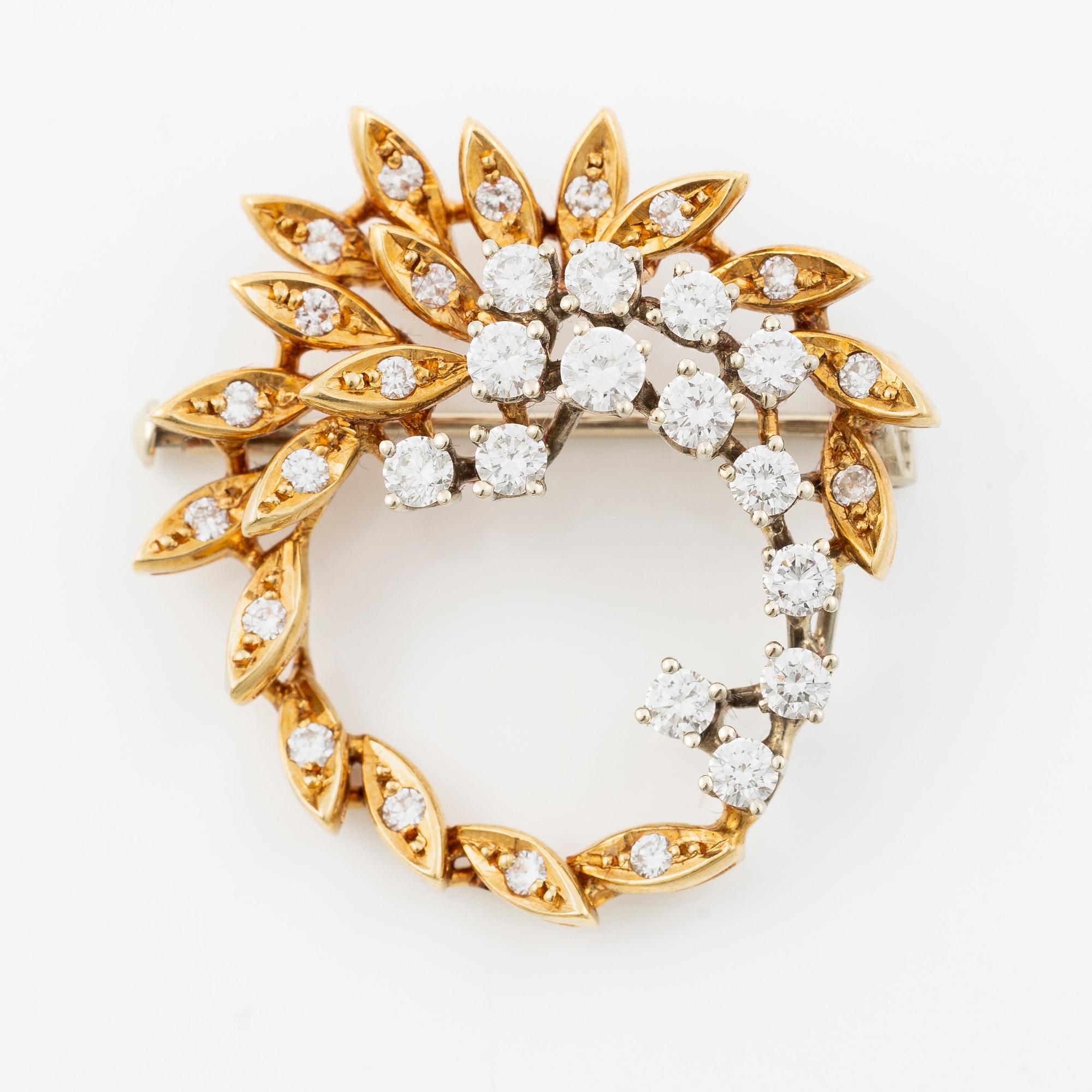 Brosch 18K guld med runda briljantslipade diamanter.