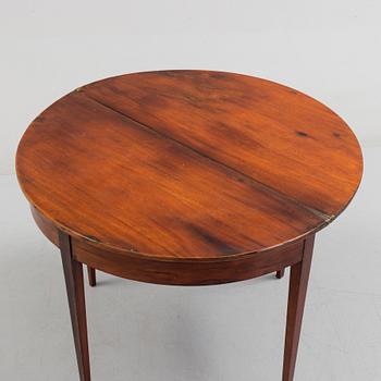 A first half od the 19th century game table veneered with mahogny.