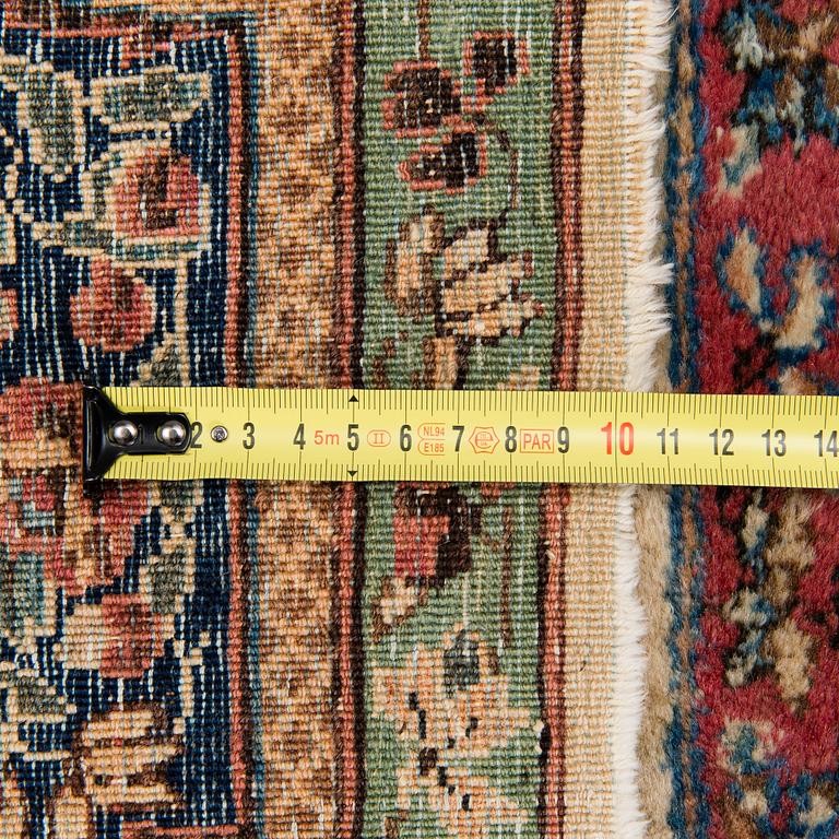 An old Kirman rug. Circa 230X125 cm.