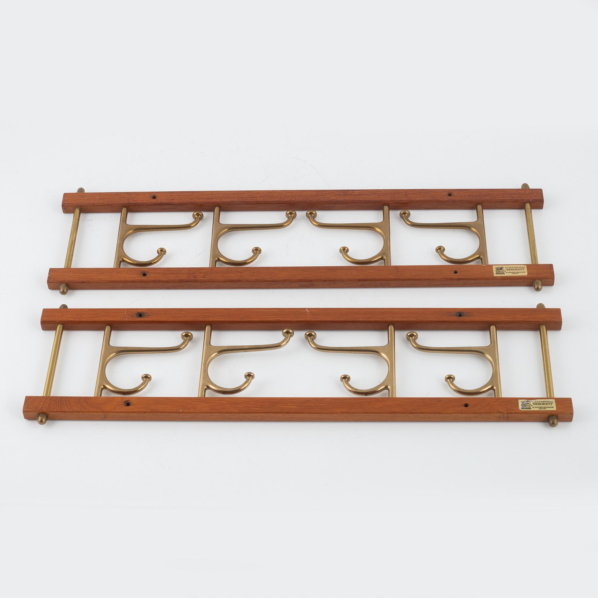 A pair of 'Dekorativ' coat hangers, Skoglunds metallgjuteri, Anderstorp, mid 20th Century.