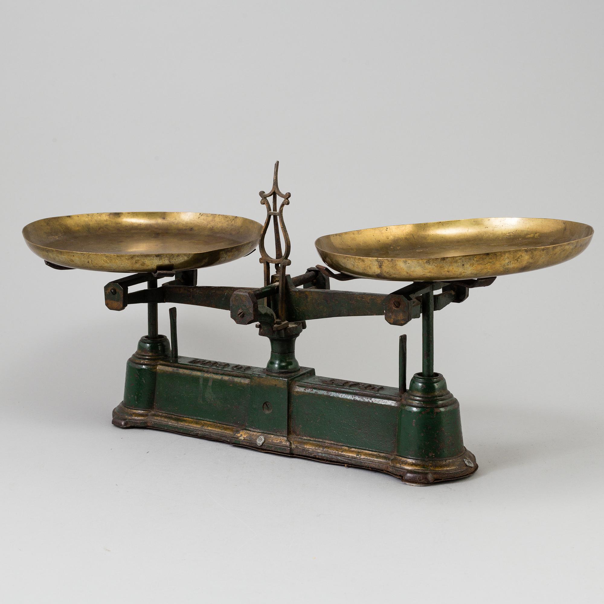 A 20th century cast iron balance with brass and iron weights, partly Skultuna, Sweden.