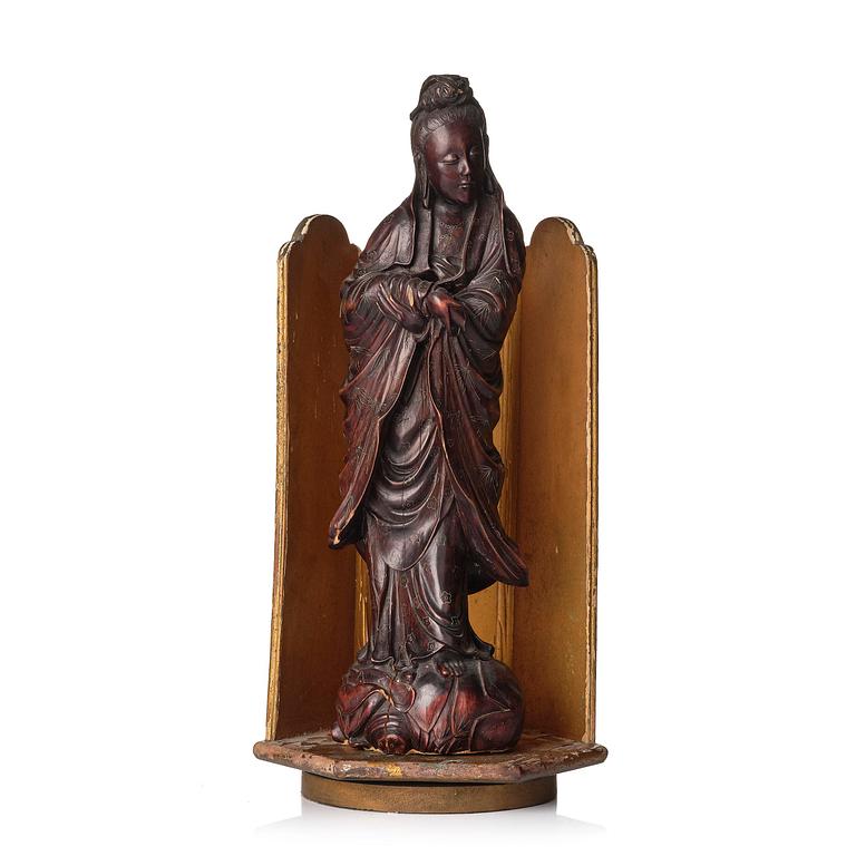 A wooden sculpture of Guanyin with metal inlay, Qing dynasty.