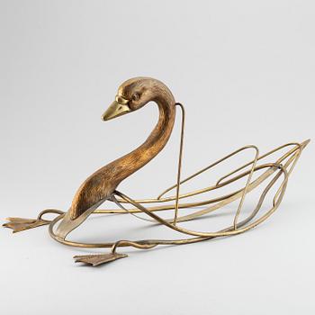 A 20th century grass newspaper stand in the shape of a swan.