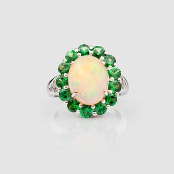 1335. An Ethiopian opal, diamond and tsavorite ring.