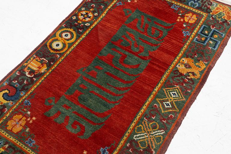 A Nepalese rug, c. 157 x 91cm.