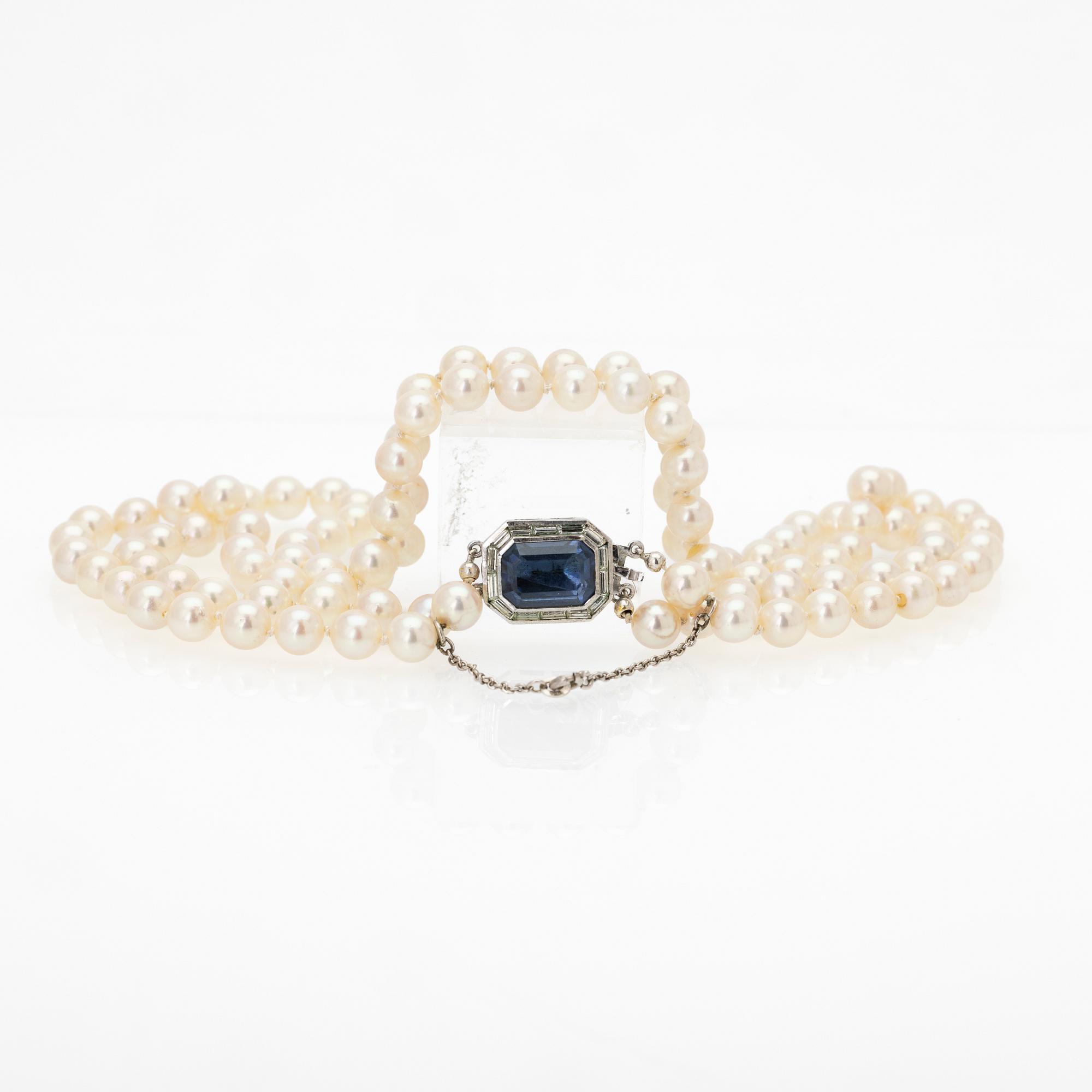 Two-row cultured pearl necklace with a silver and glass clasp.
