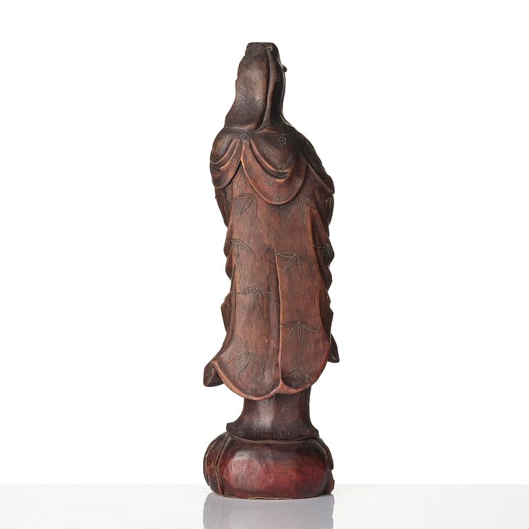 A wooden sculpture of Guanyin with metal inlay, Qing dynasty.