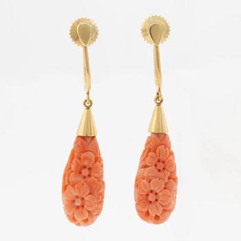 A pair of 18K gold earrings with coral drops.