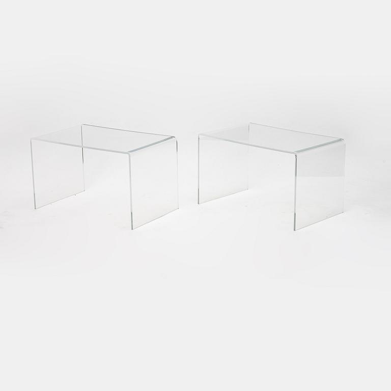 A contemporary pair of plastic tables.