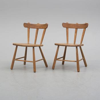 a paor of 1940's pine wood chairs.