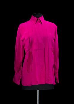 A 1980s cerise silk blouse by Yves Saint Laurent.