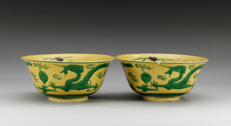 A pair of yellow ground 'dragon bowls', Qing dynasty, with Kangxis six character mark.