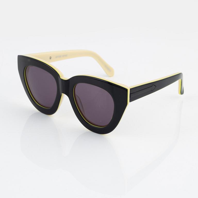 Karen Walker, a pair of "Anytime" sunglasses.