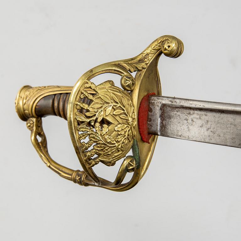 An end of the 18th Century Swedish sabre and a 19th century French century sabre, both with scabbards.