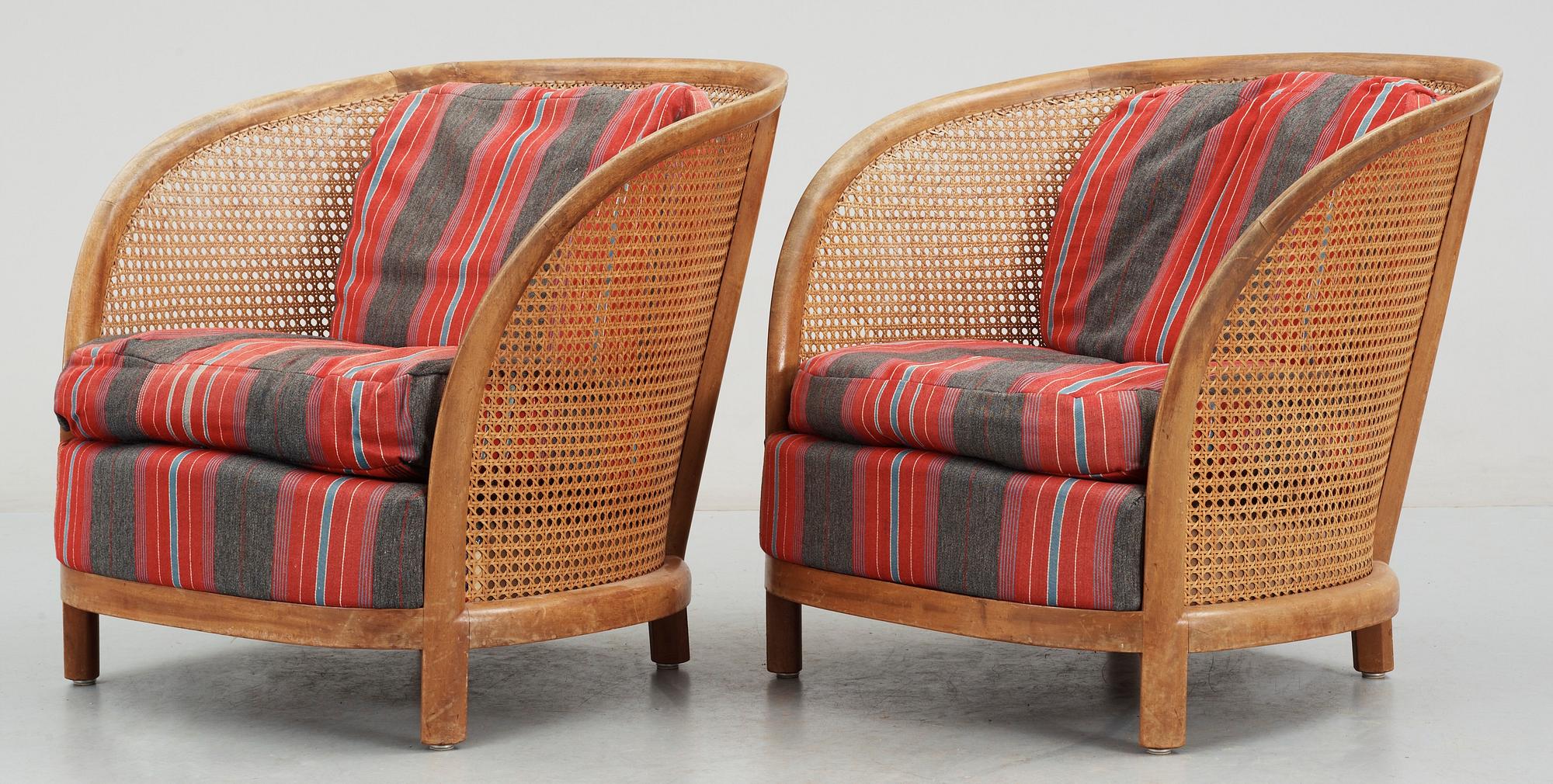A pair of Oscar Nilsson beech and rattan arm chairs.