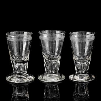 A glass bottle and three vodka glasses, 19th Century.