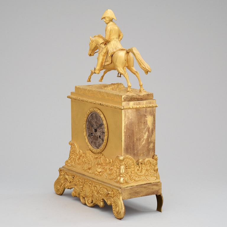 A Swedish Empire Equestrian gilt bronze mantel clock depicting king Karl XIV Johan.