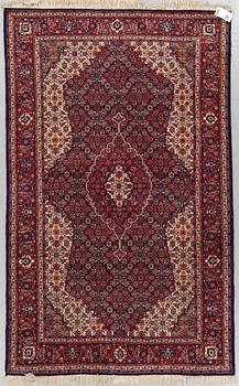 An oriental rug, around 204 x 125 cm.