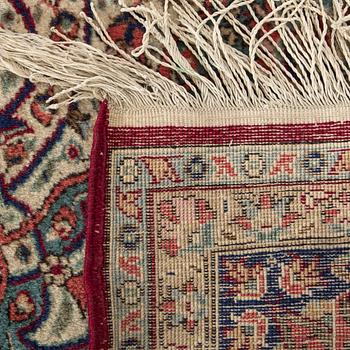 An old Kirman carpet ca 303 x 202 cm.