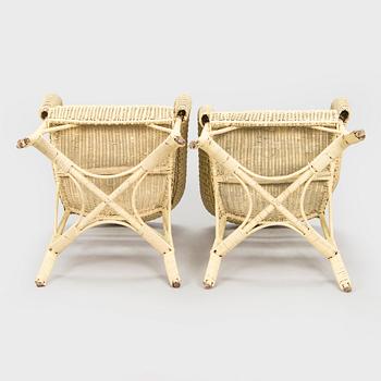 A mid-20th-century three-piece rattan furniture set including two armchairs, and a table.