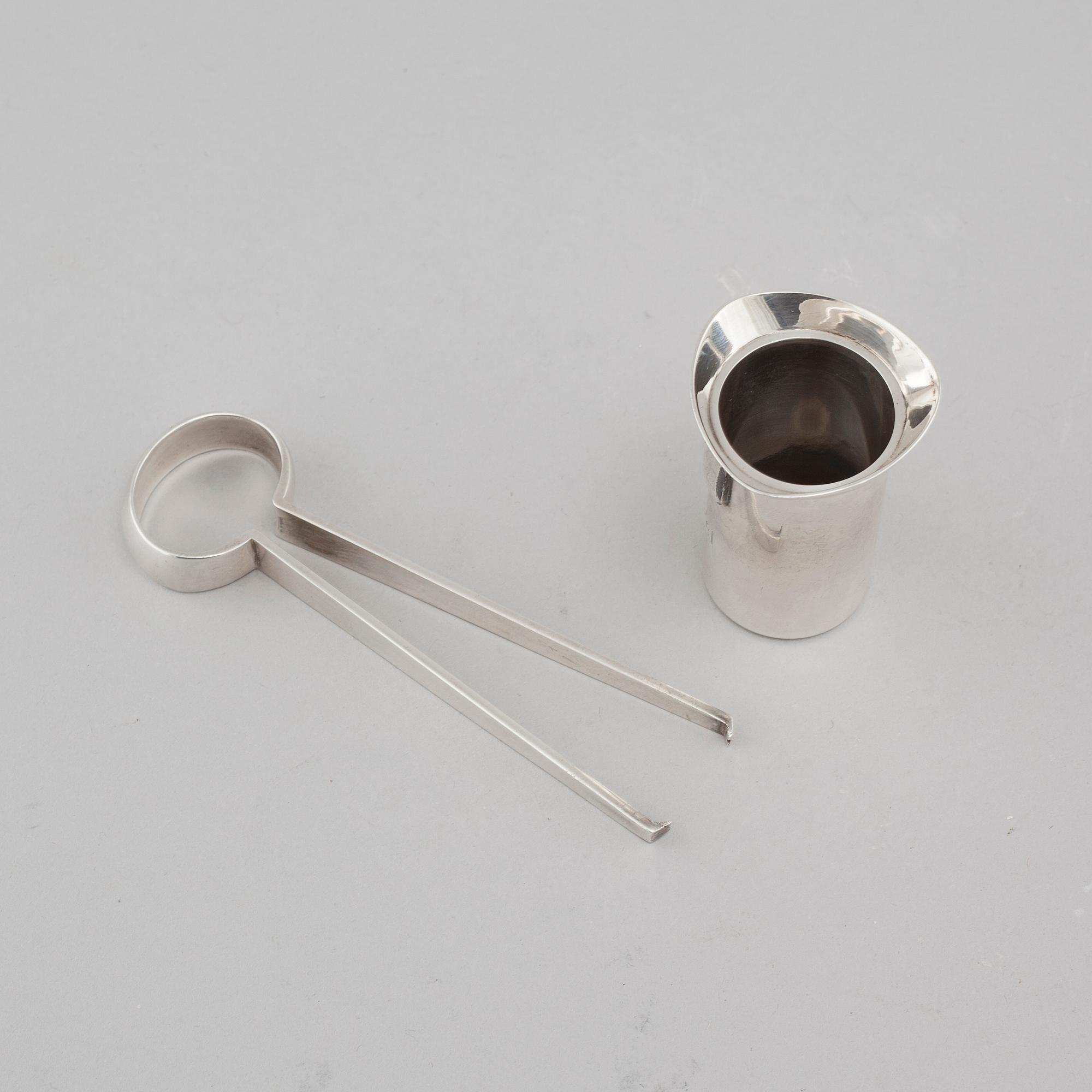 Two silver drink accessories with finnish stamps.