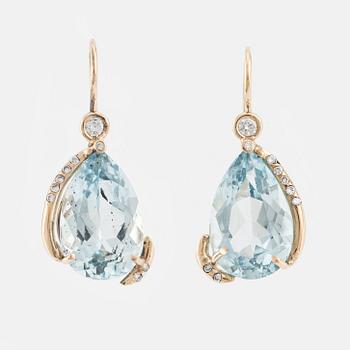 Earrings with drop-shaped faceted blue topazes and brilliant-cut diamonds.