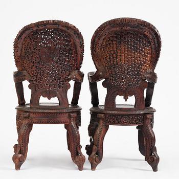 A pair of carved 'blackwood' armchairs, Bombay presidency, British Raj, circa 1880.