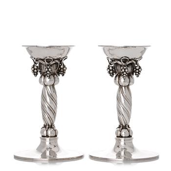 153. Georg Jensen, a pair of sterling silver grape decorated candlesticks, Copenhagen 1996, design nr 263B.