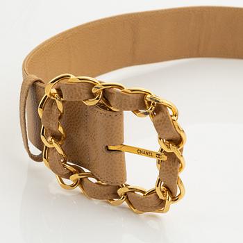 Chanel, a beige caviar letaher and gold tone metal belt.