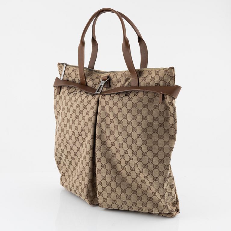 Gucci, a logo canvas tote bag.