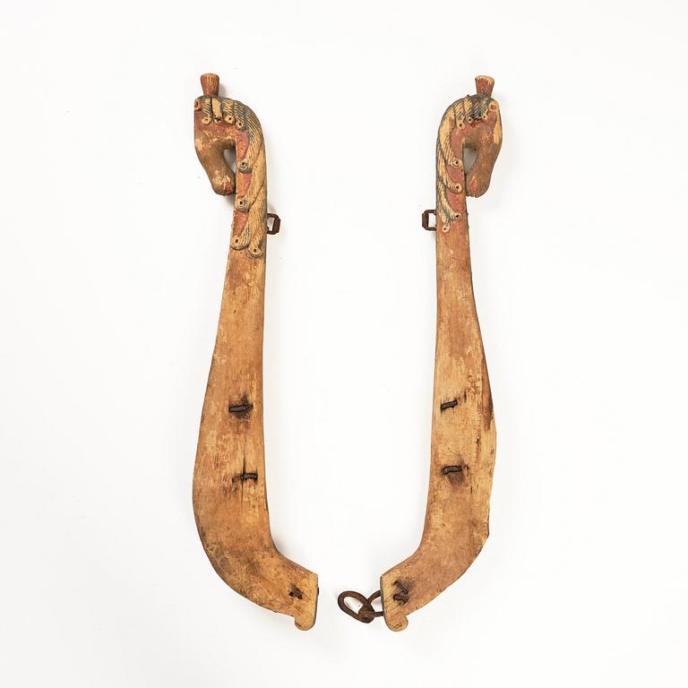 A pair of Swedish carved and painted horse harness parts, 18th century.