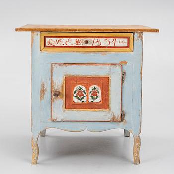 A Swedish folk art polychrome-painted table from Järvsö, Hälsingland, dated 1834.