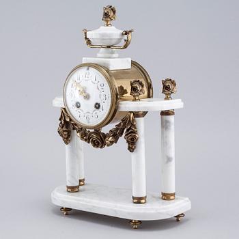 A French mantlepiece clock and a pair of candelabras, first half of the 20th century.