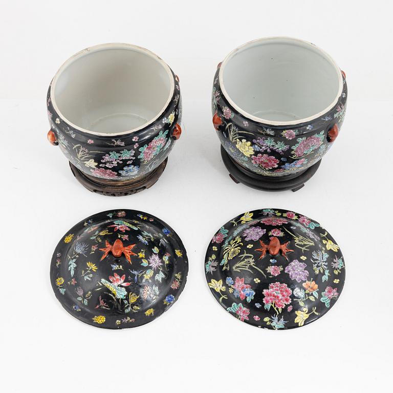 A pair of Famille Noir porcelain urns with covers, China, 20th century.