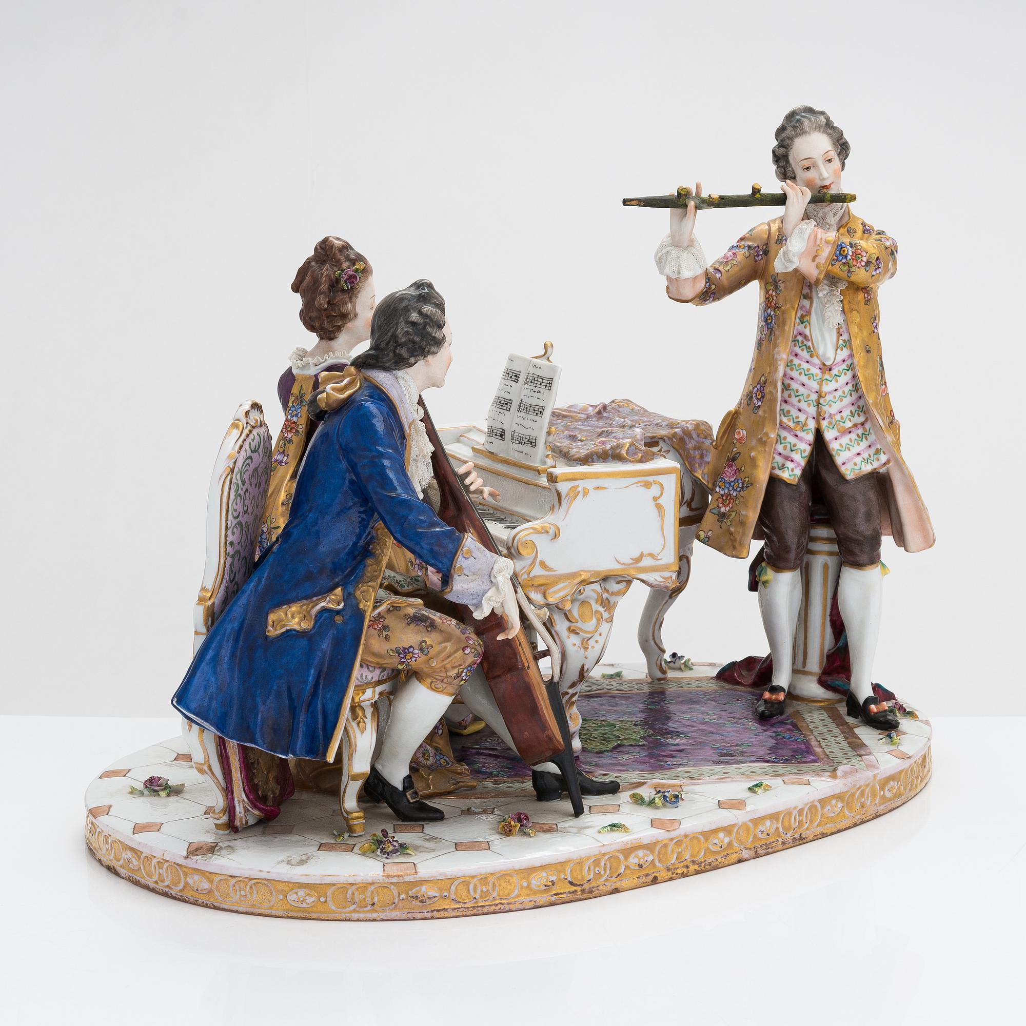 A Volkstedt porcelain musical trio figurine, mid-20th century. Length 40 cm.