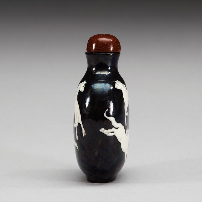 An enamelled porcelain snuff bottle with stopper, Qing dynasty.