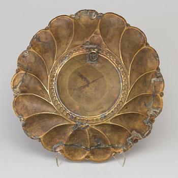 A 17th century brass wall plaque.