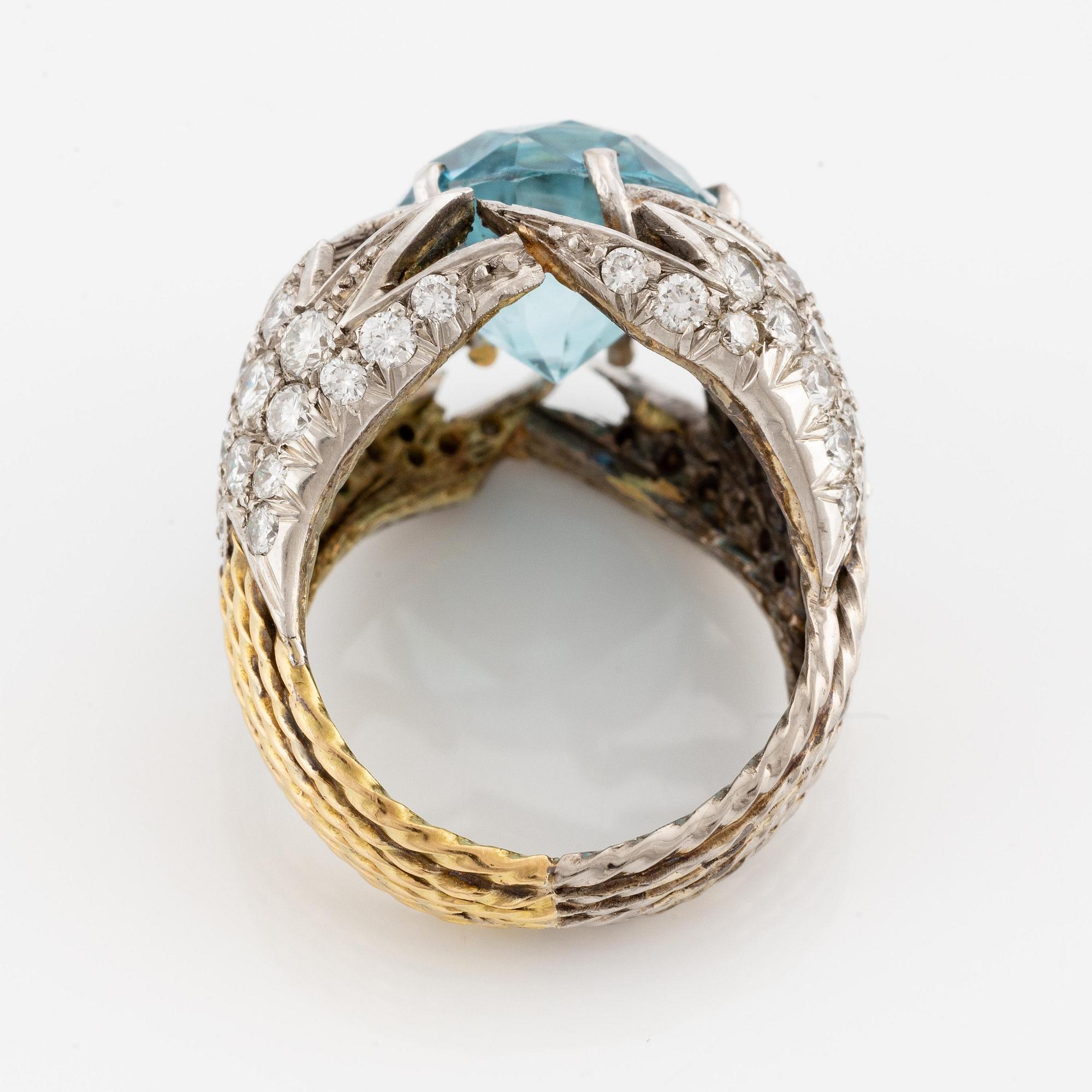 Sterlé ring 18K guld och platina med en blå fasettslipad zirkon och runda briljantslipade diamanter.