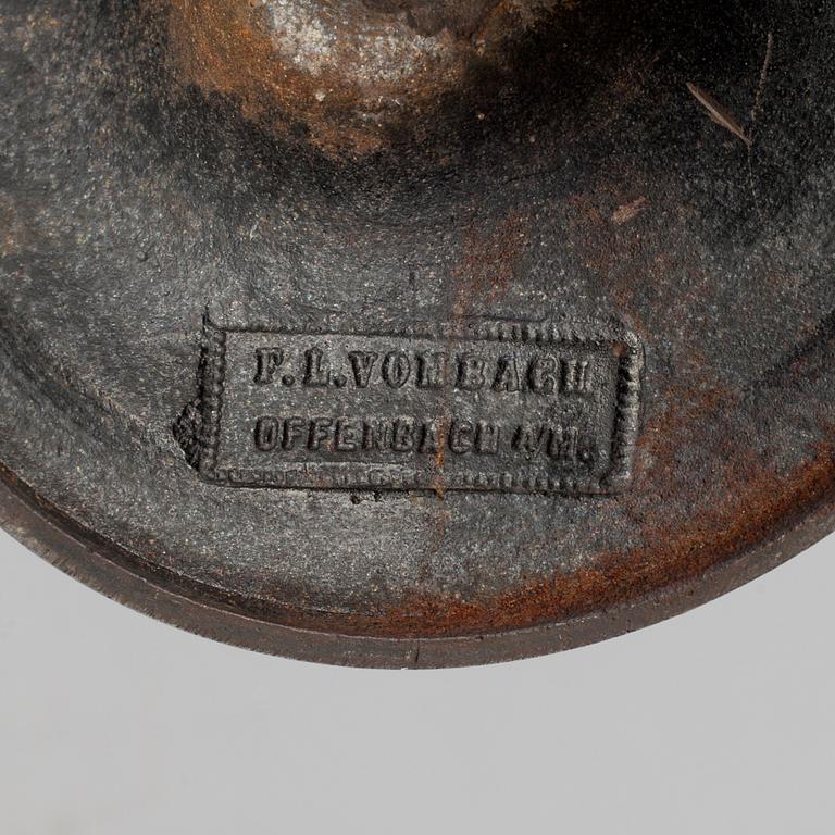 A 19th century iron candlestick marked F.L Vombach Offenbach A/M.