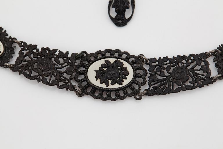 A Berlin steel and iron parure comprising a necklace, two bracelets and a brooch.