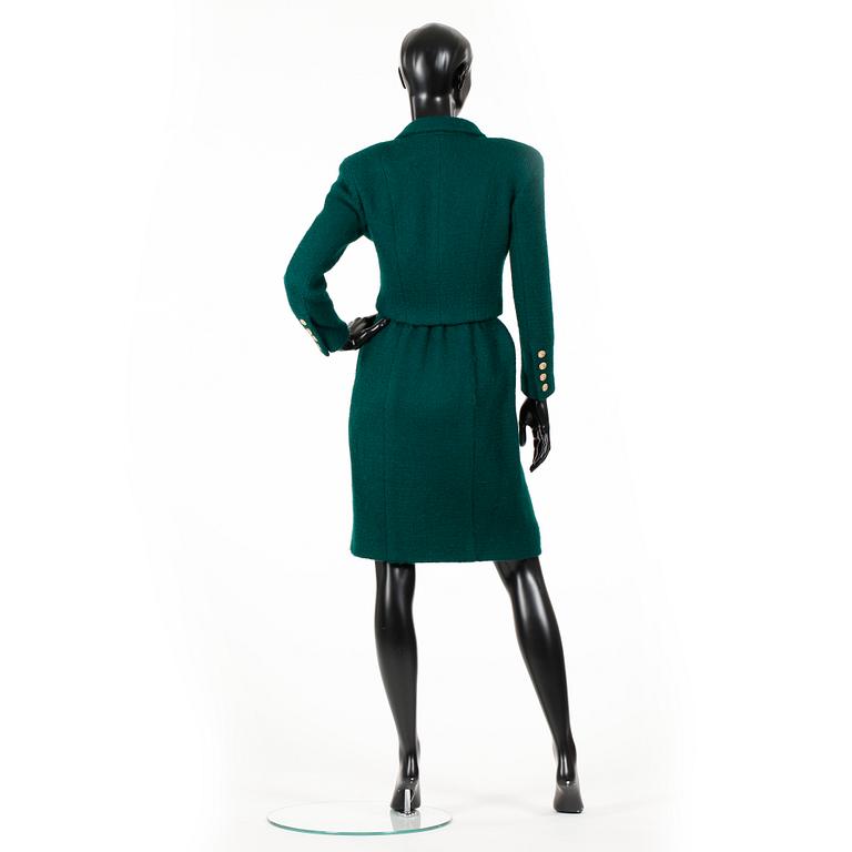 CHANEL, a two-piece suit consisting of short jacket and skirt.