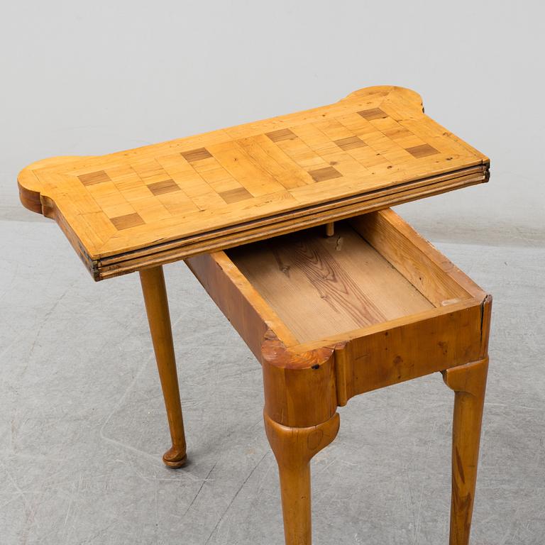 An end of the 19th Century Queen Anne-style card table.