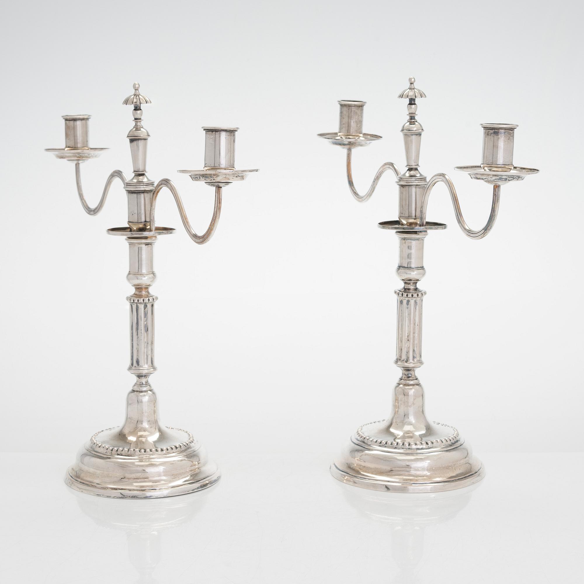 A pair of silver candelabra by Ferdinand Christian Krebs, Breslau, 1776-1792, with snuffers from Reval. Neo-classicism.