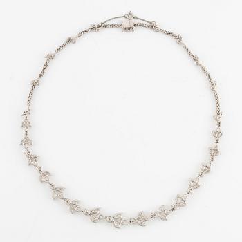 A platinum necklace set with navette-, pear- and round-brilliant-cut diamonds.