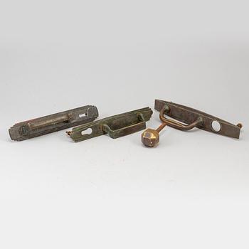 Four bronze art déco door handles, 1930s.