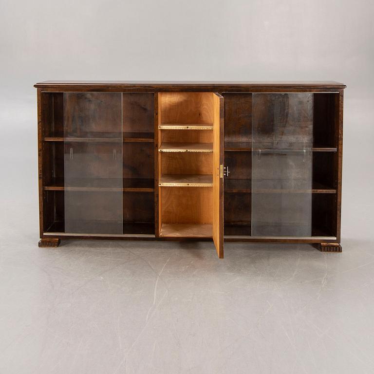 A 1930s birch book cabinet.