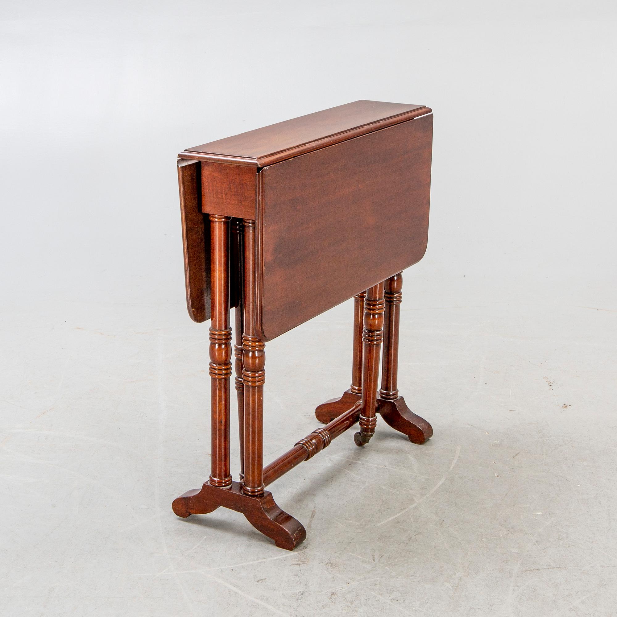 A 20th century English mahogany folding table.
