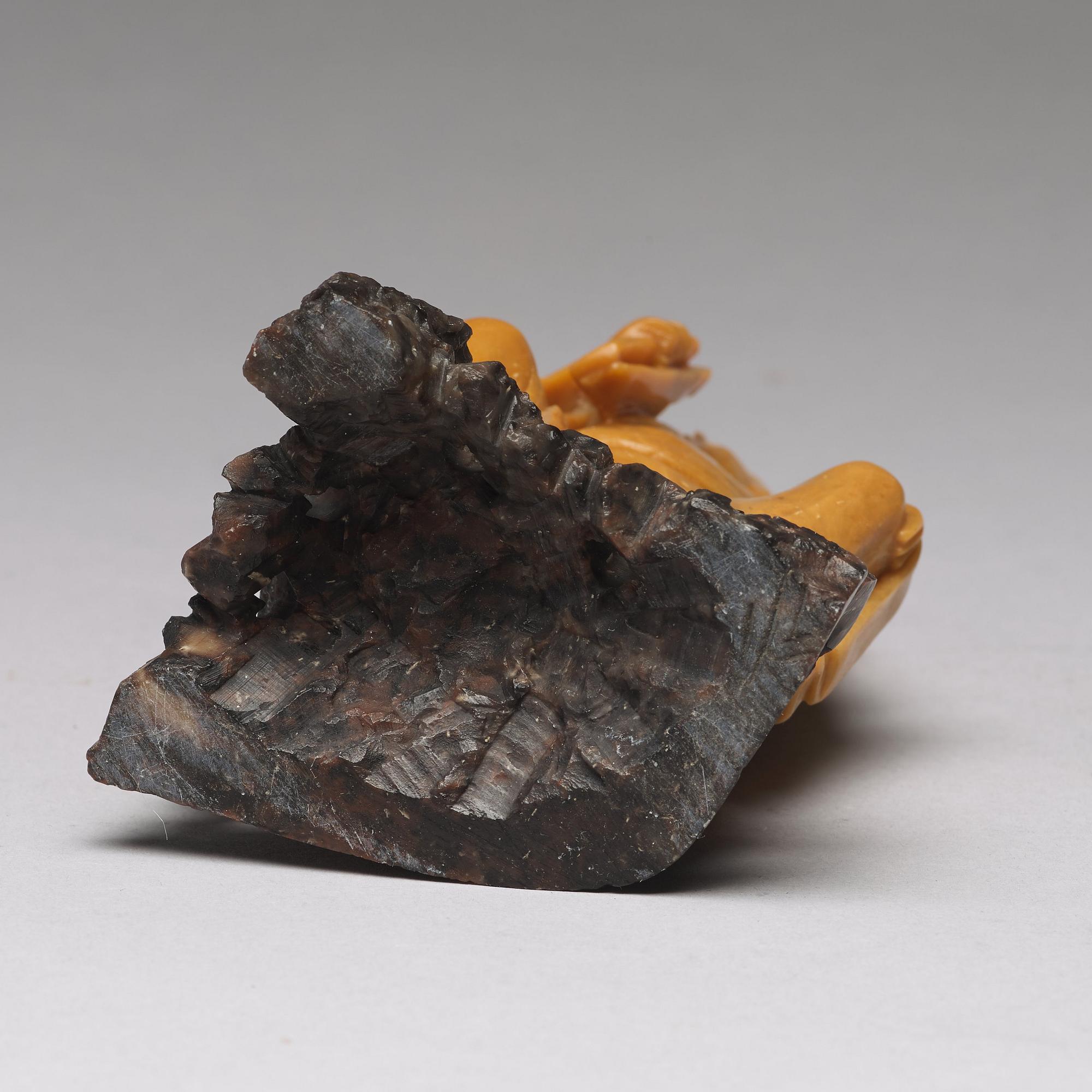 A soapstone figure of a seated scholar, late Qing dynasty, circa 1900.